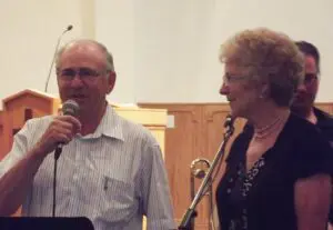 Walter and Anne Parschauer speak to the Middle Lake Gospel Church during their farewell ceremoney.