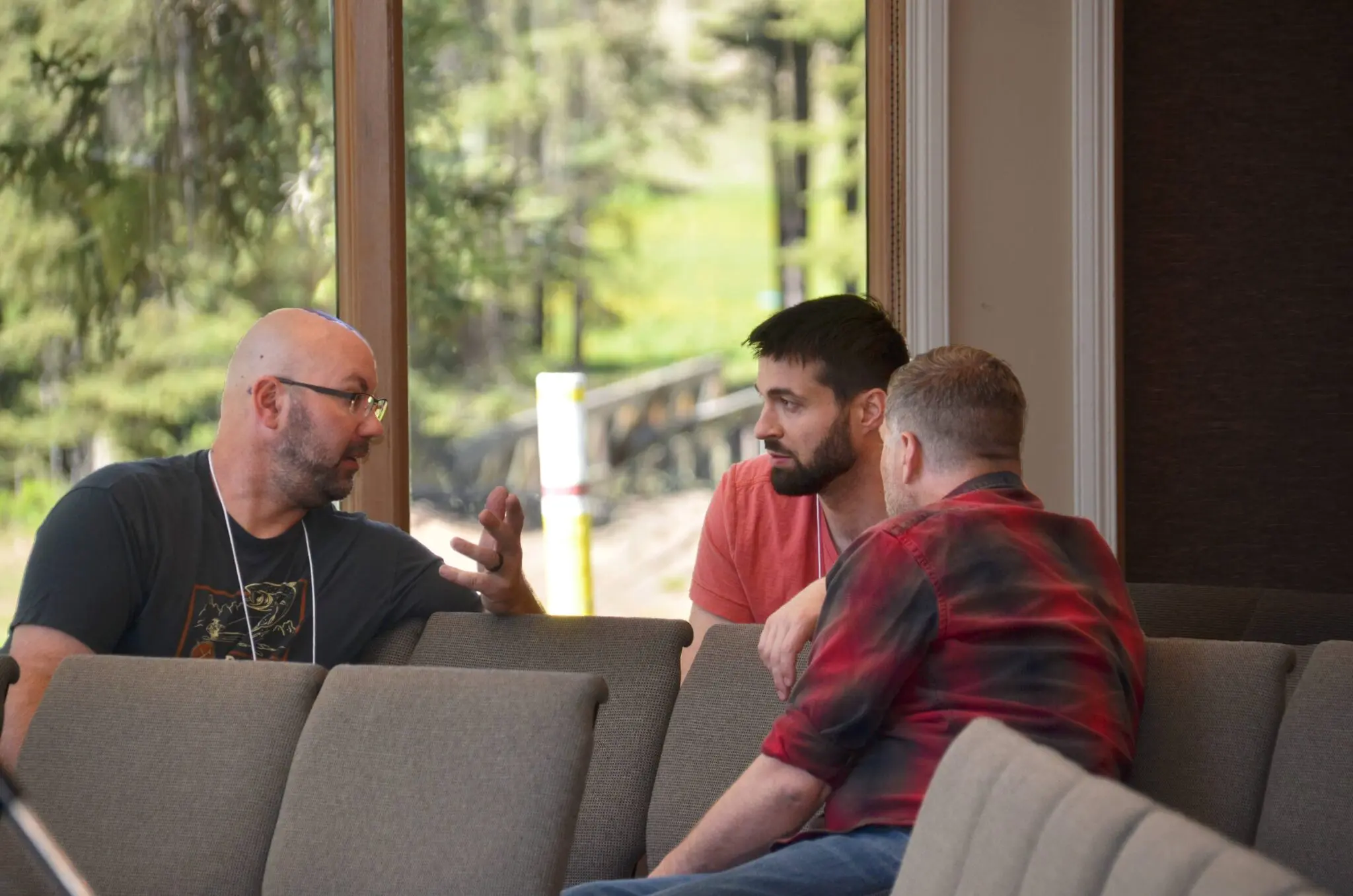 Jay Foster talks with 2 men.