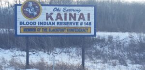 This photo of the Kainai Indian Reserve sign reminds us of reaching First Nations people in rural Canada.