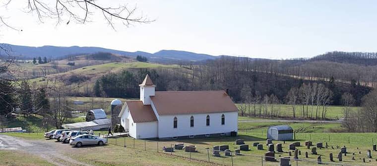 A small church is not a stepping stone to bigger and better; this photo of a little white church illustrates the value of small church ministry.